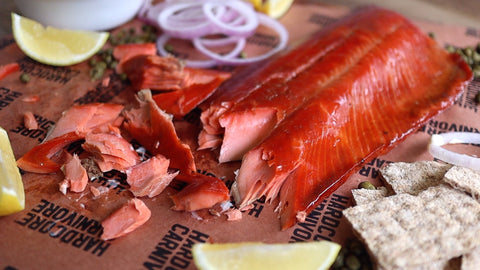 Flaked smoked wild coho salmon served with lemon, red onion and crackers